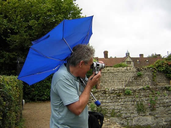 Dad taking pictures in the rain and wind at the Mote